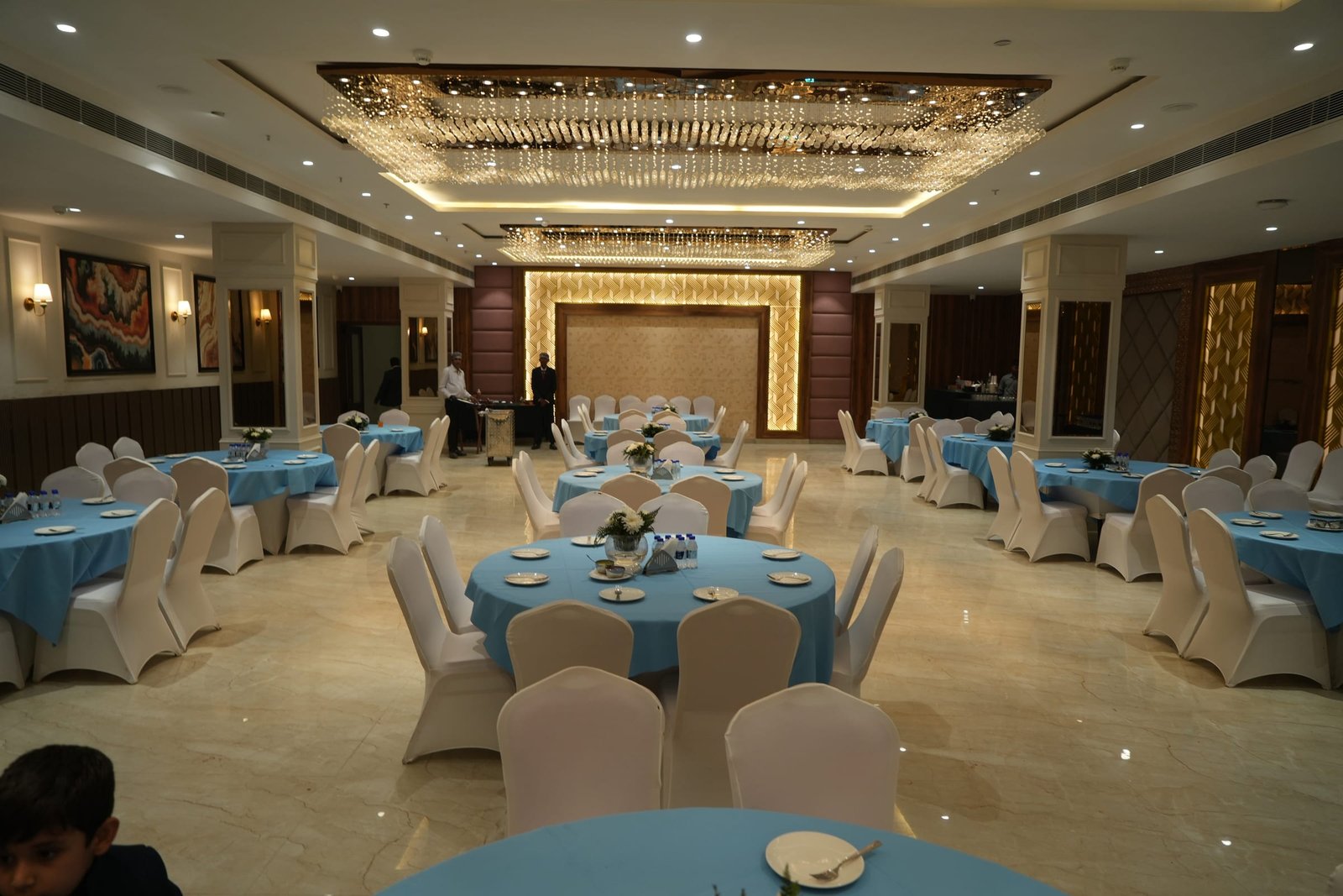 Round tables and covered chairs across the banquet floor