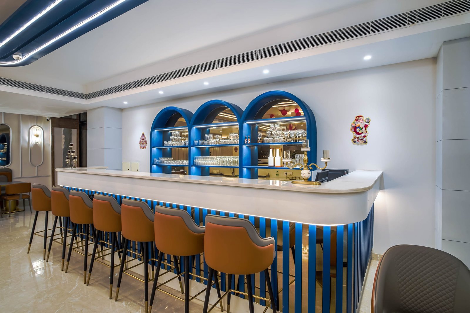 The bar counter with stools under blue arches