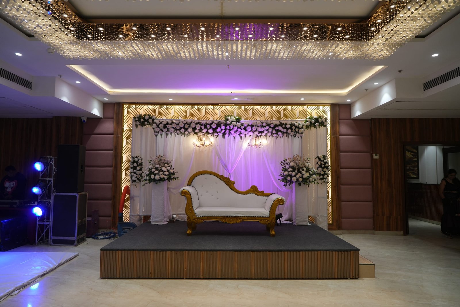 The same stage under violet lighting, ready for a reception