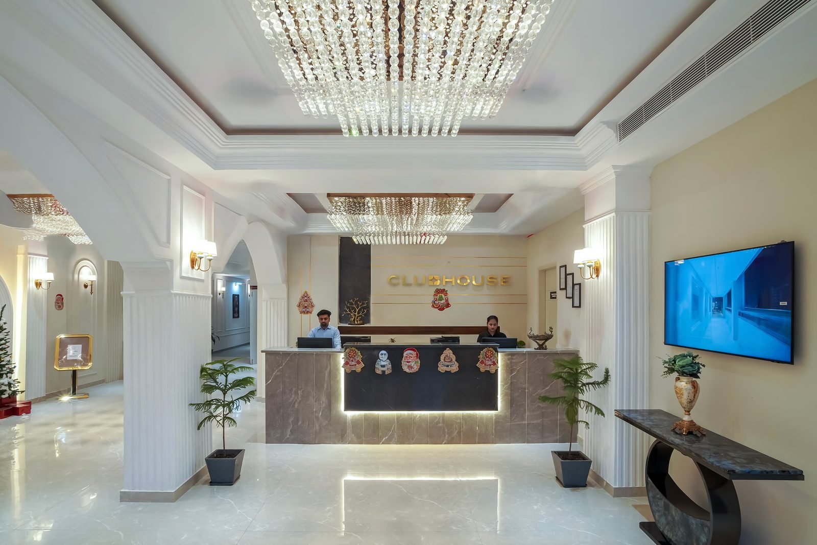 Reception hall with chandeliers and a marble front desk