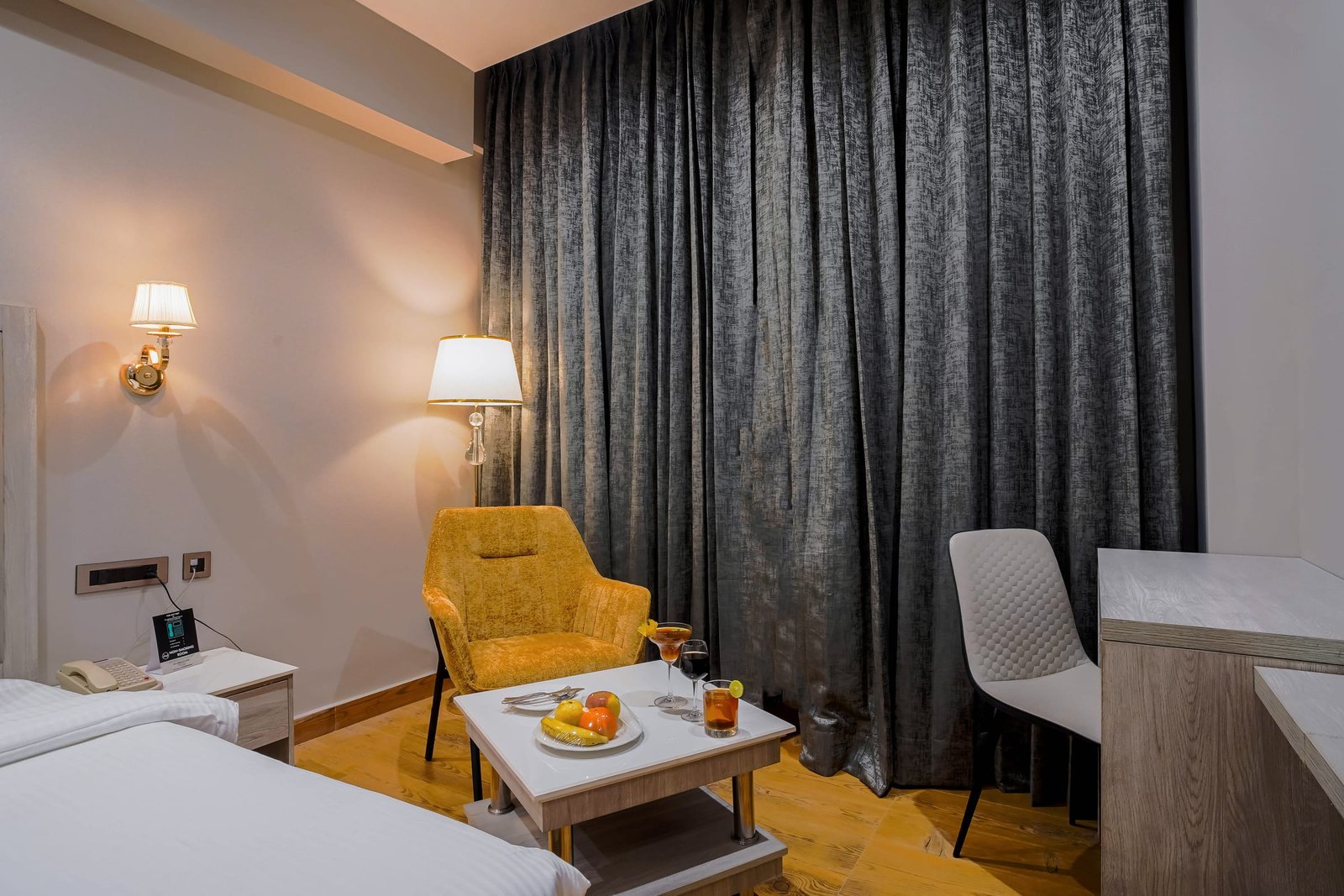Twin-bed room with a work desk along the wall