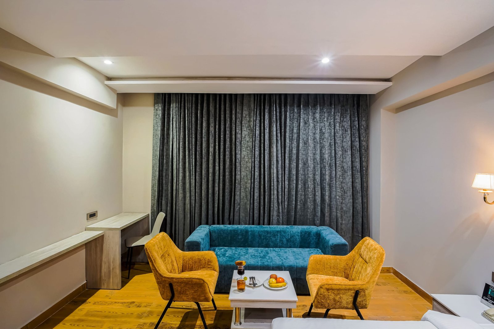 Suite with a teal sofa and a separate seating corner