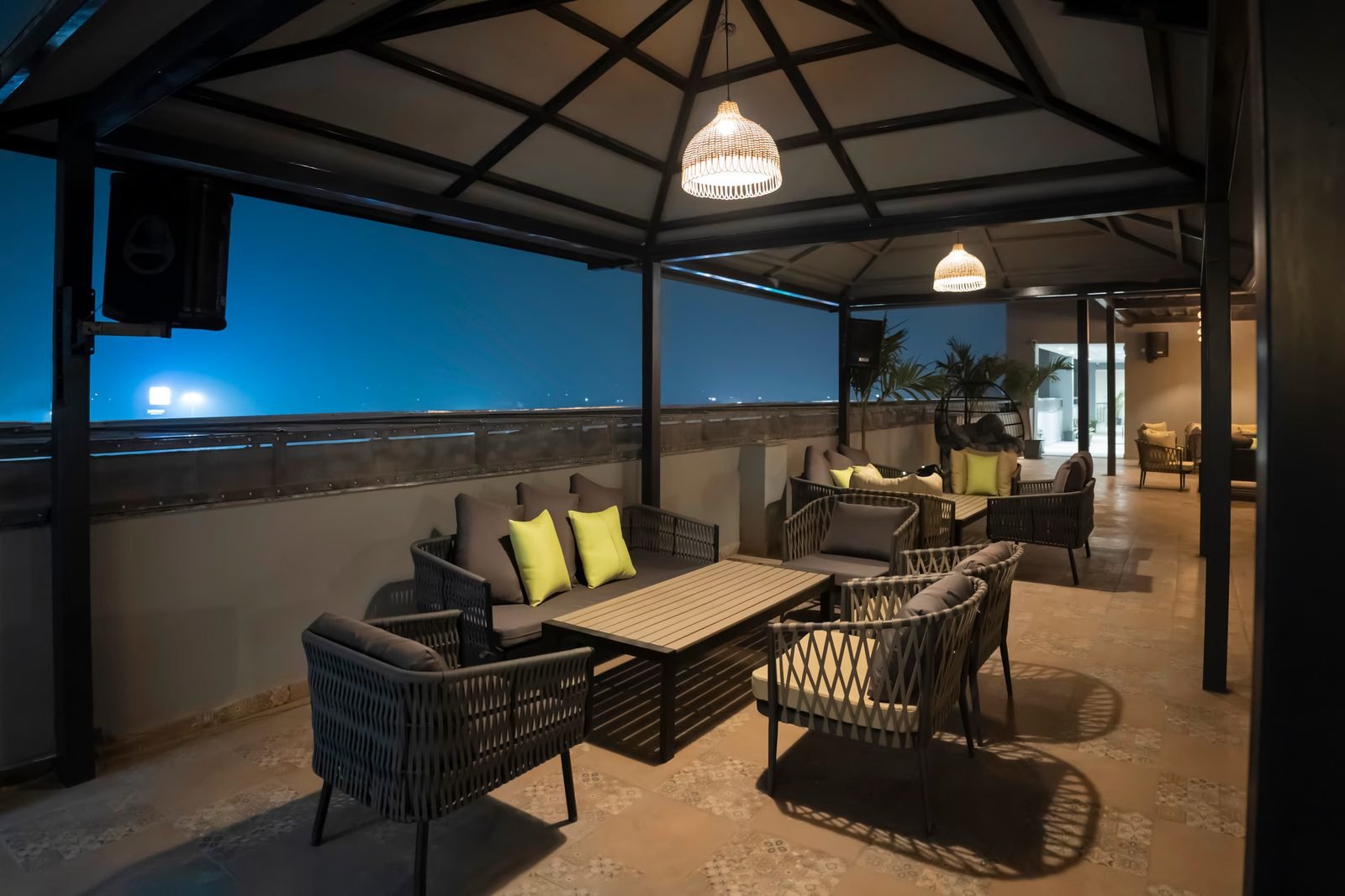 Rooftop gazebo seating overlooking the city at night