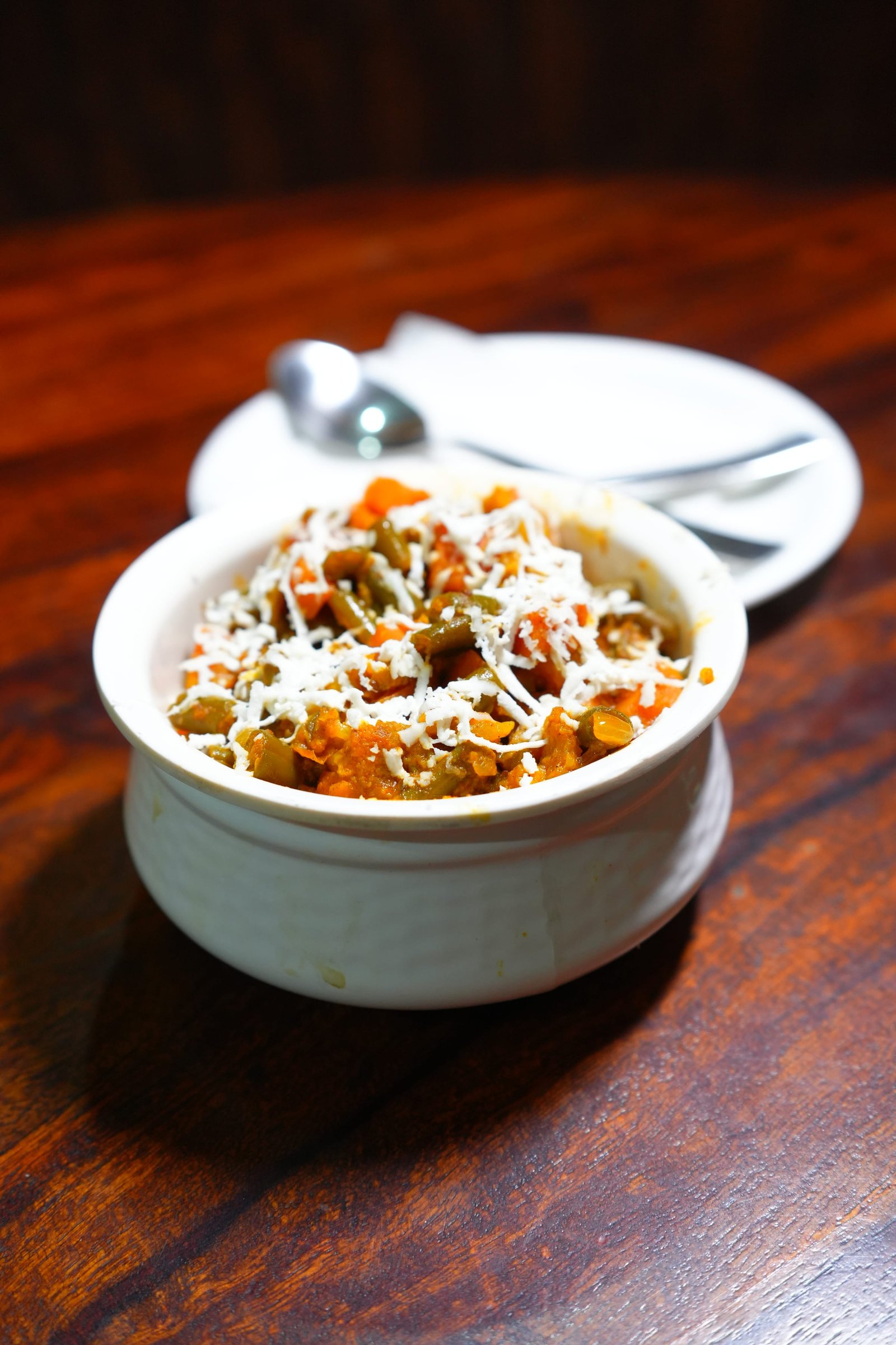 A vegetable dish topped with grated cheese
