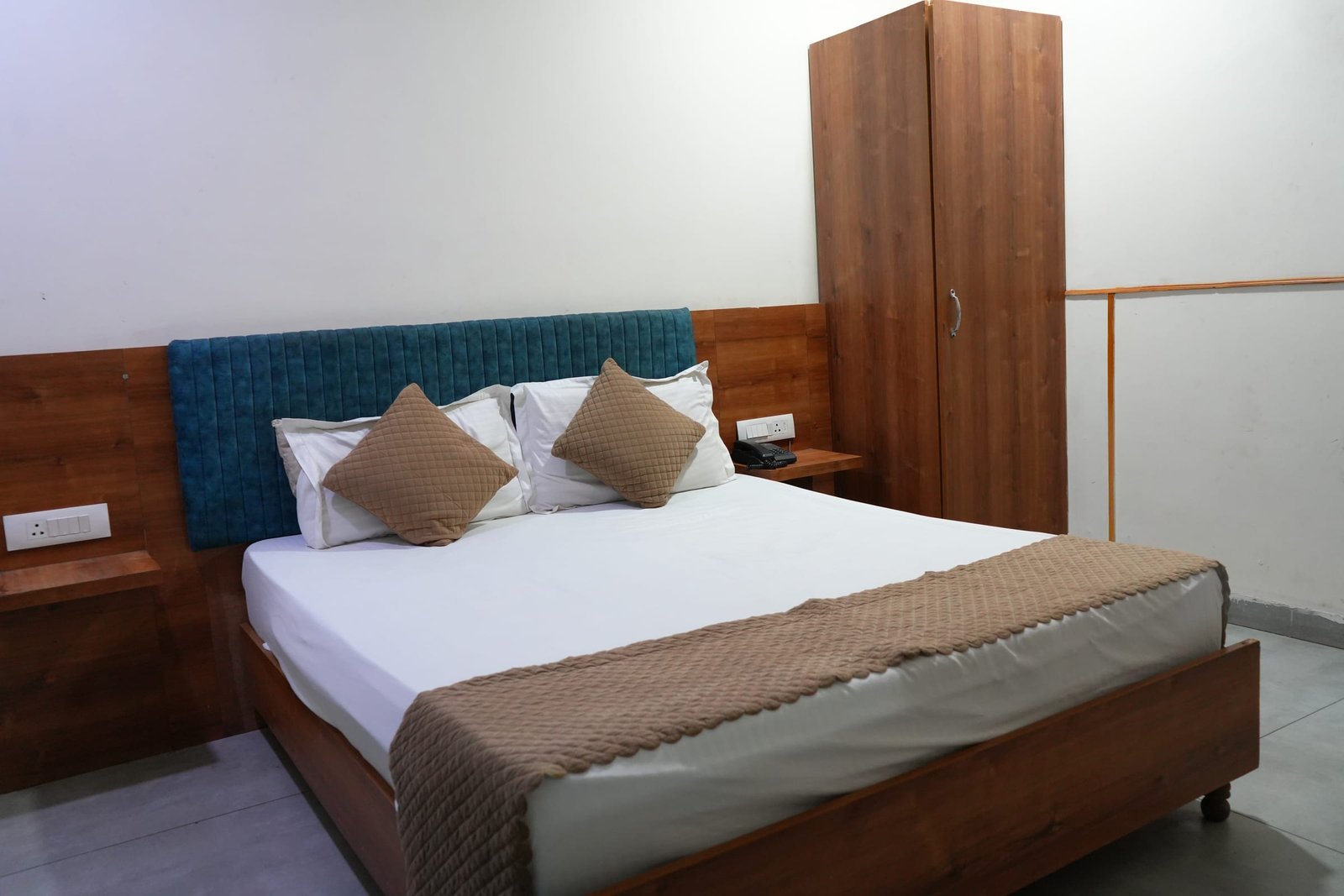 The room seen from the doorway, bed against the panelled wall
