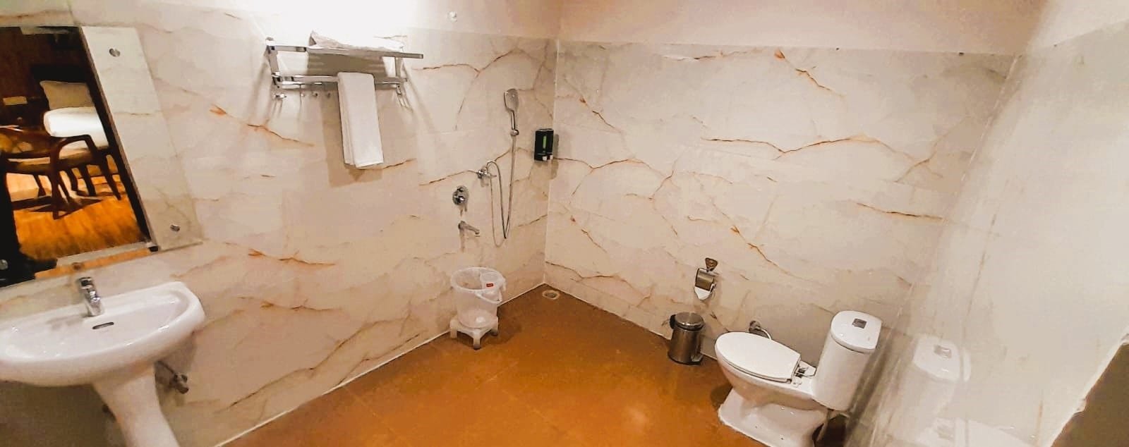 Hut bathroom with a stone floor and a basin