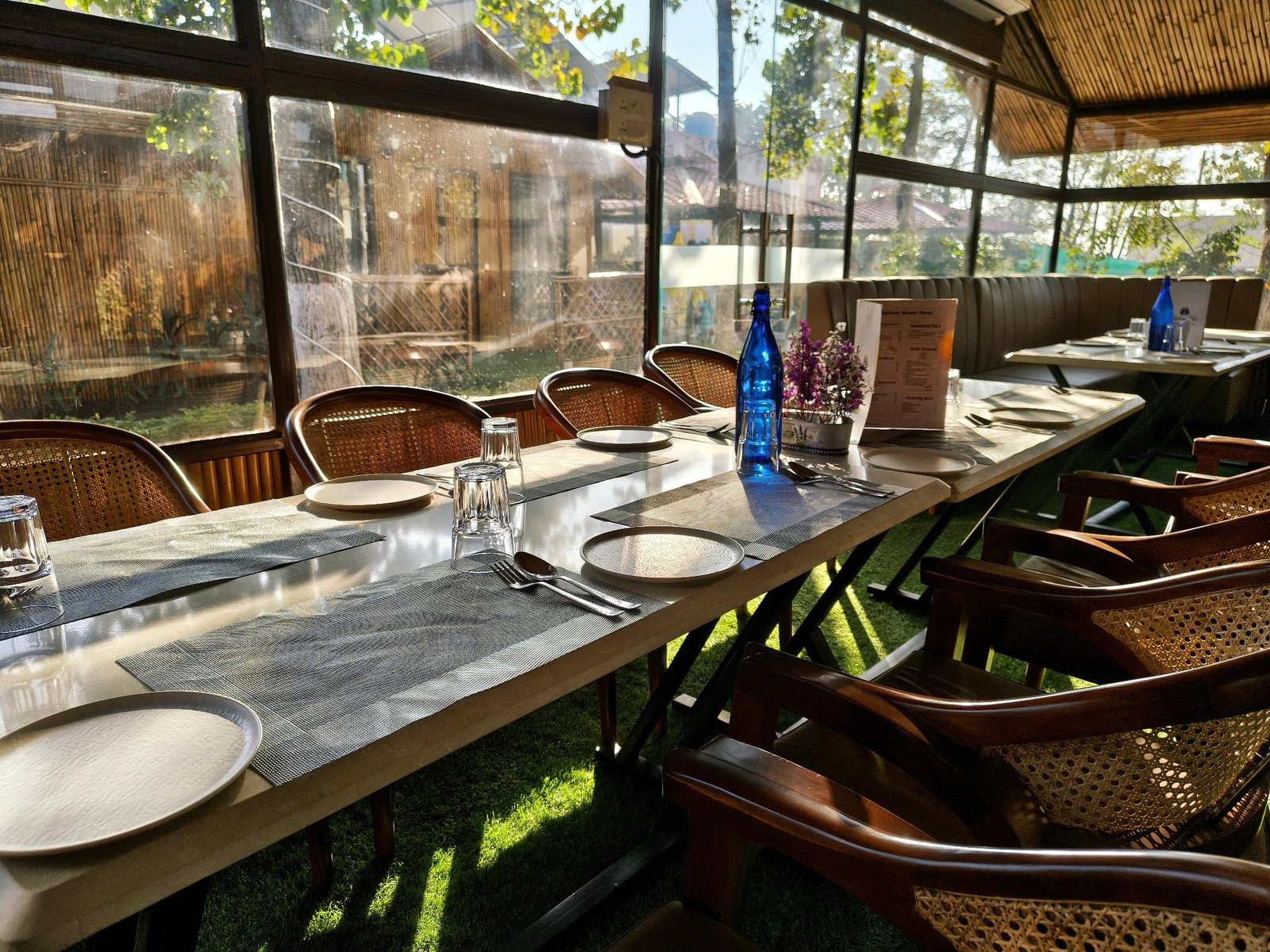 The long table laid for a sitting in the dining pavilion