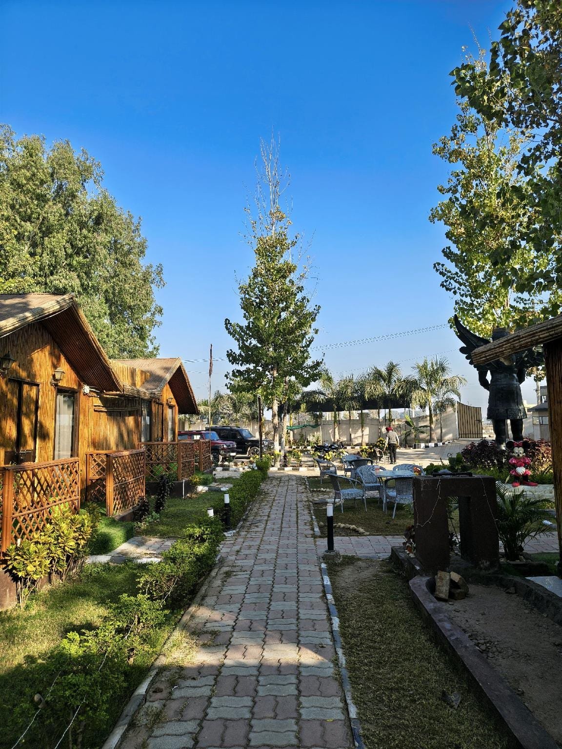 The path between the huts, planted either side
