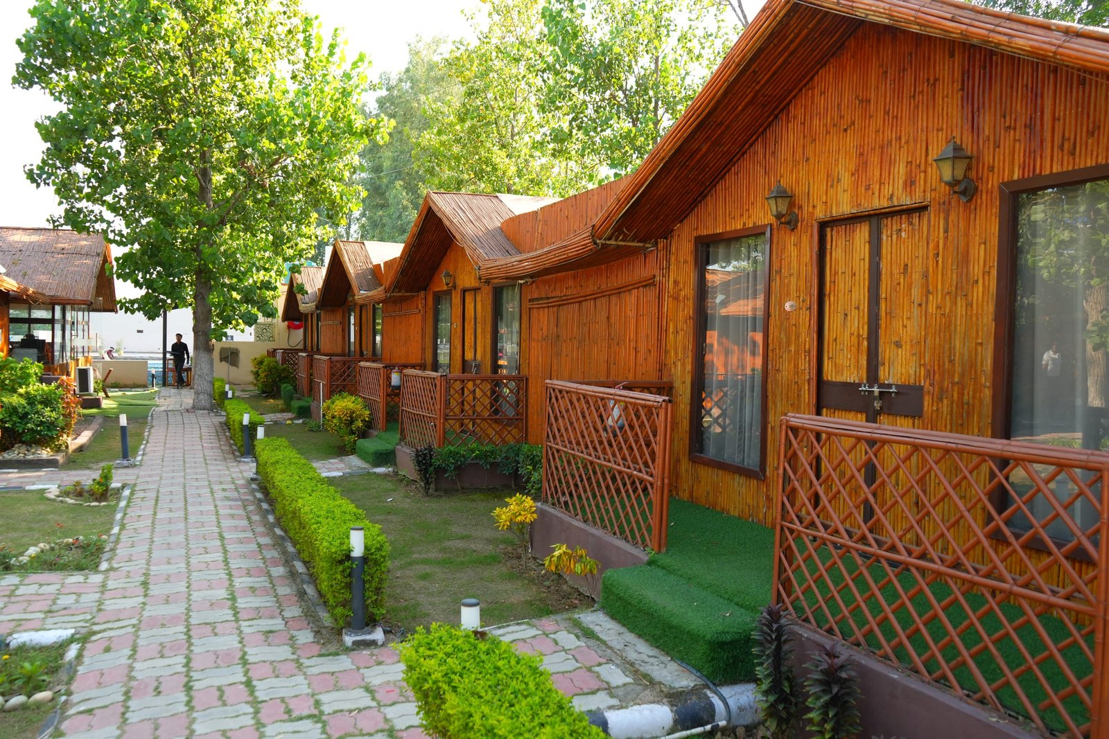 The paved path running between the two rows of huts