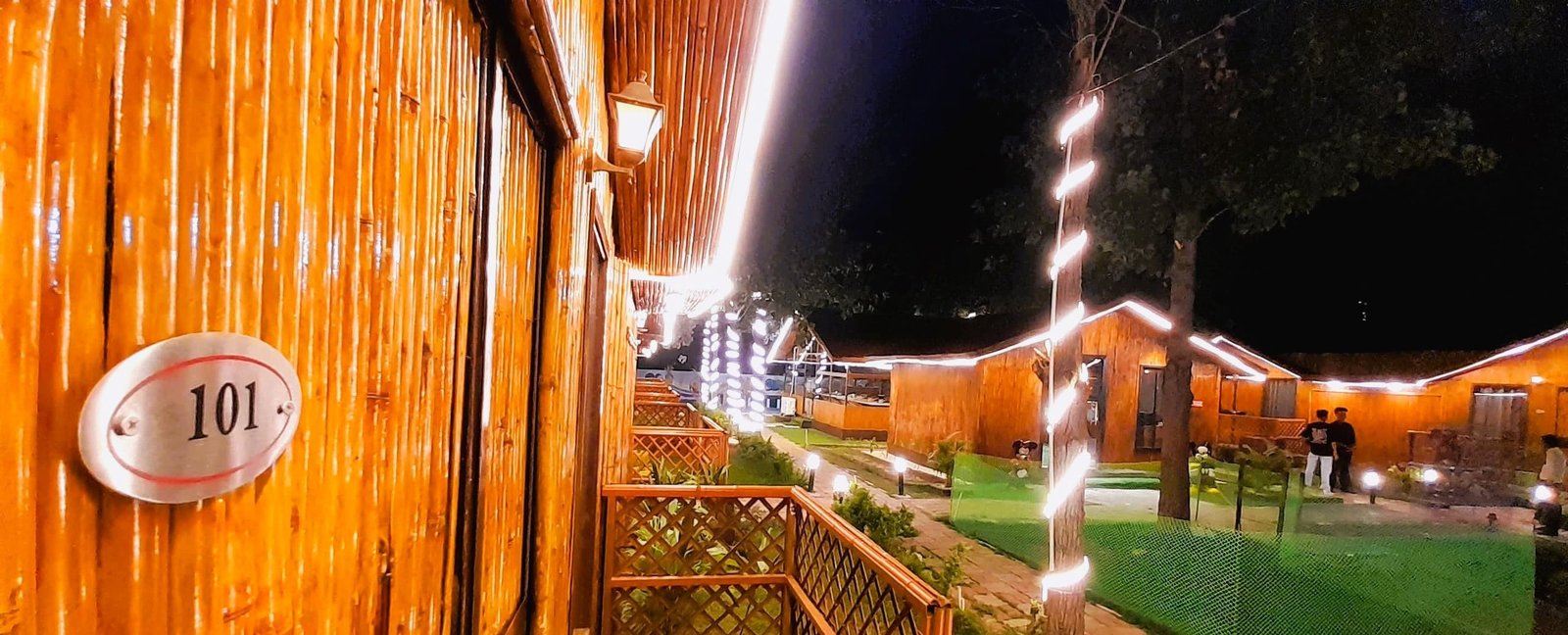 The huts after dark, strung with lights