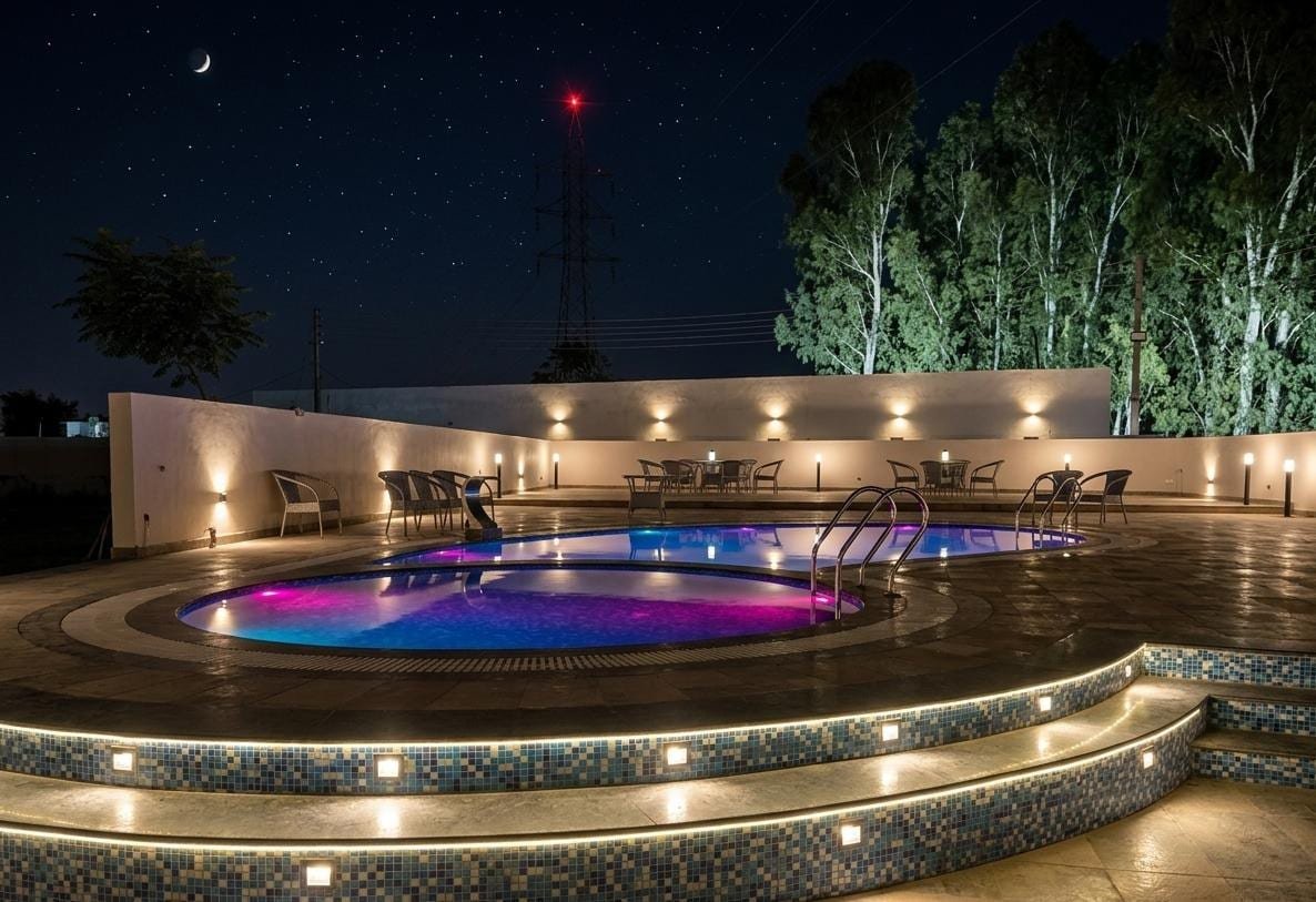 Loungers set around the pool after dark