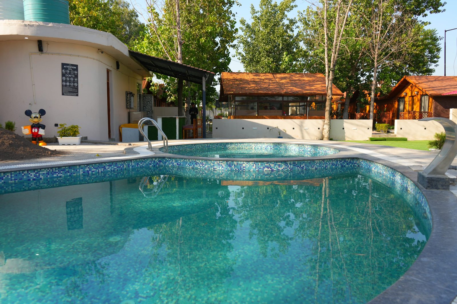 The pool with the huts behind it