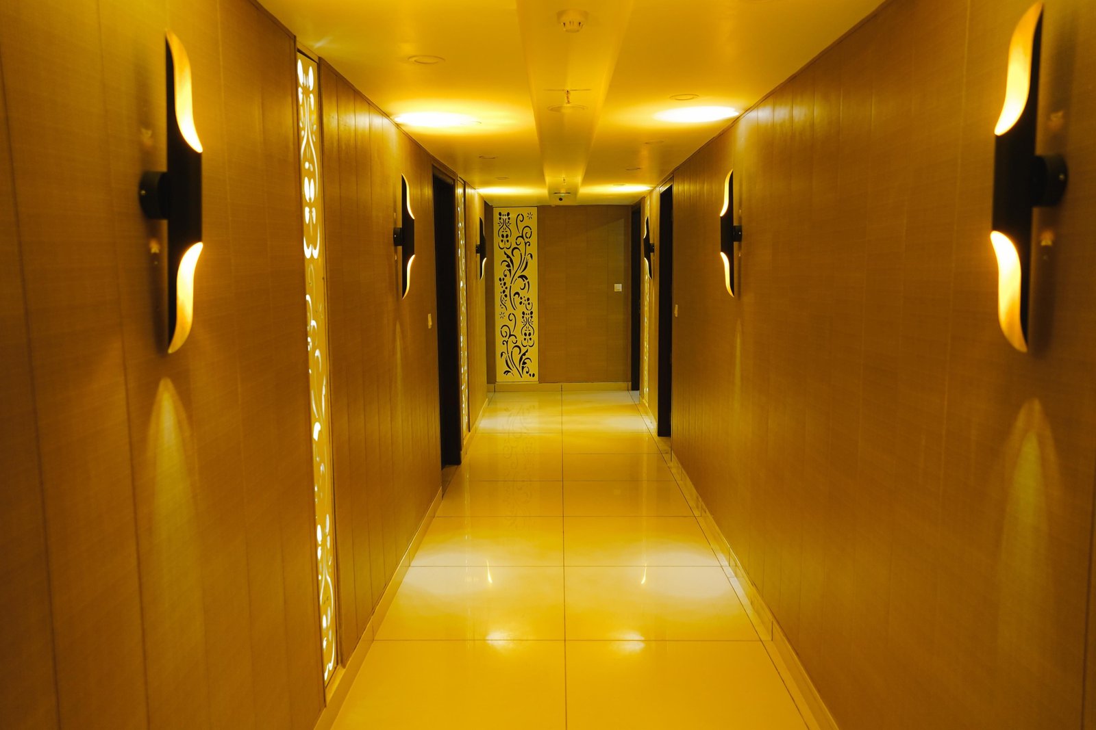 A guest-floor corridor under its wall sconces