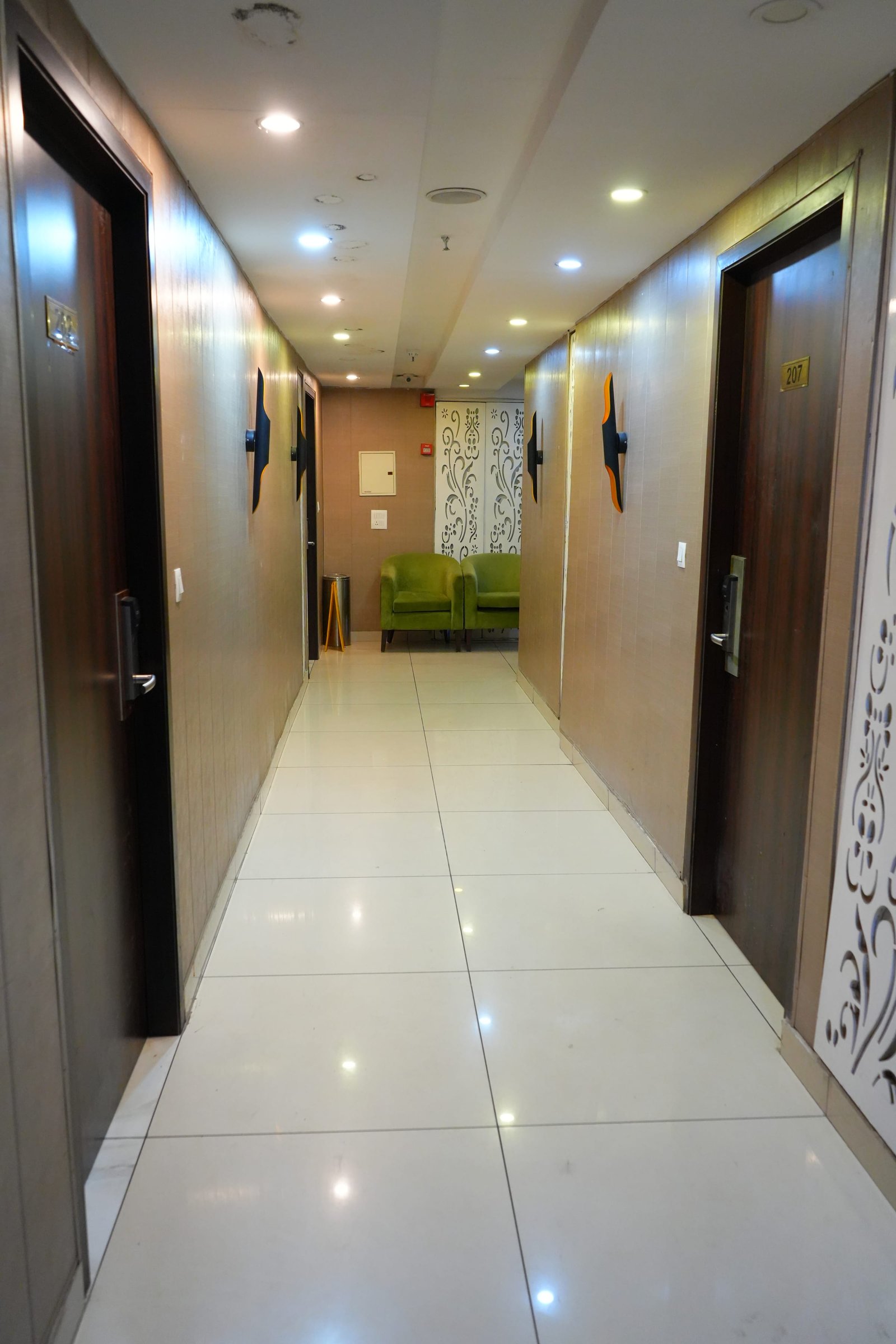 A guest-floor corridor towards a chair at the far end