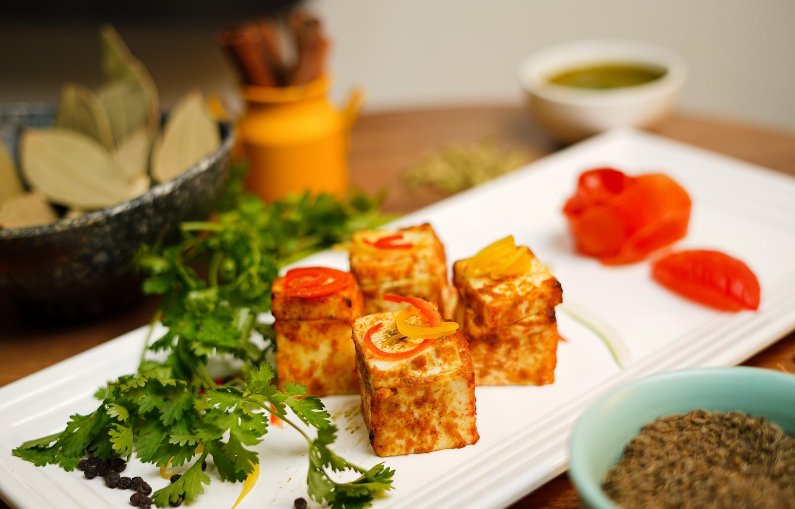 Paneer tikka plated with chutneys